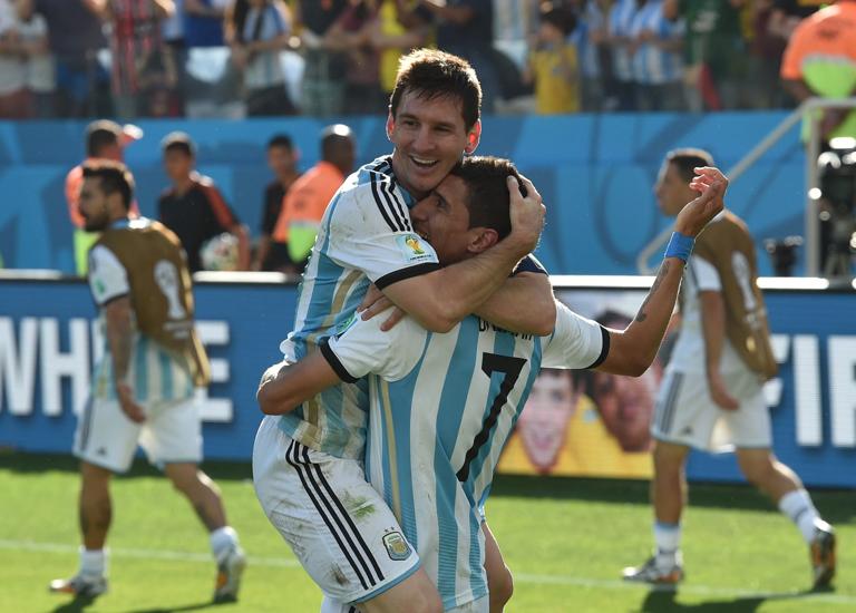 Argentina's forward and captain Lionel Messi (L) and Argentina's midfielder Angel Di Maria celebrate after scoring the 1-0 during a Round of 16 football match between Argentina and Switzerland at Corinthians Arena in Sao Paulo during the 2014 FIFA World Cup on July 1, 2014.     AFP PHOTO / NELSON ALMEIDA        (Photo credit should read NELSON ALMEIDA/AFP via Getty Images)