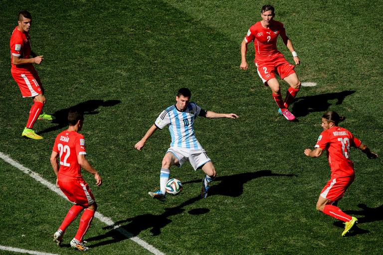 SAO PAULO, BRAZIL - JULY 01: Lionel Messi of Argentina controls the ball against Josip Drmic (L), Fabian Schar (2nd L), Stephan Lichtsteiner (2nd R) and Ricardo Rodriguez of Switzerland during the 2014 FIFA World Cup Brazil Round of 16 match between Argentina and Switzerland at Arena de Sao Paulo on July 1, 2014 in Sao Paulo, Brazil. (Photo by Matthias Hangst/Getty Images)