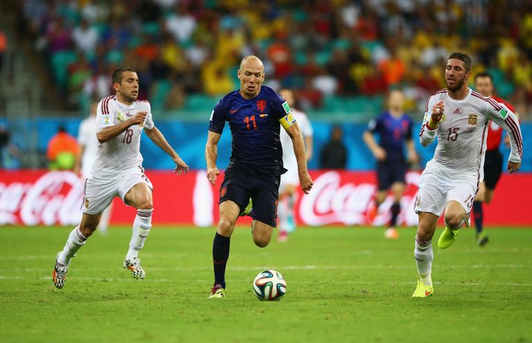 SALVADOR, BRAZIL - JUNE 13:  Arjen Robben of the Netherlands beats Sergio Ramos and Jordi Alba during the 2014 FIFA World Cup Brazil Group B match between Spain and Netherlands at Arena Fonte Nova on June 13, 2014 in Salvador, Brazil.  (Photo by Paul Gilham/Getty Images)